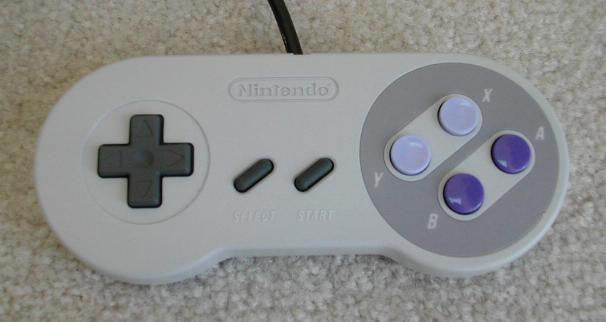 a nintendo wii game controller sitting next to a wii controller 